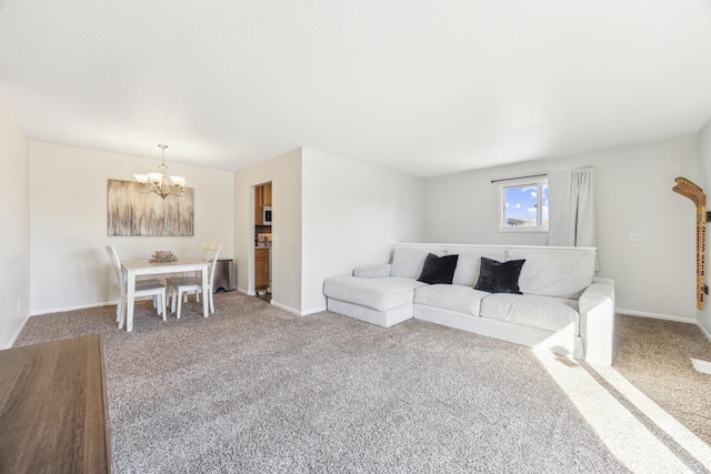 carpeted living room featuring a notable chandelier