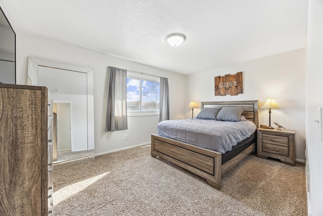 carpeted bedroom featuring a textured ceiling