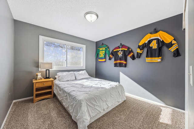 bedroom featuring a textured ceiling and carpet flooring