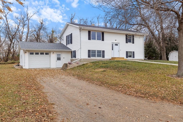 split foyer home with a garage and a front lawn