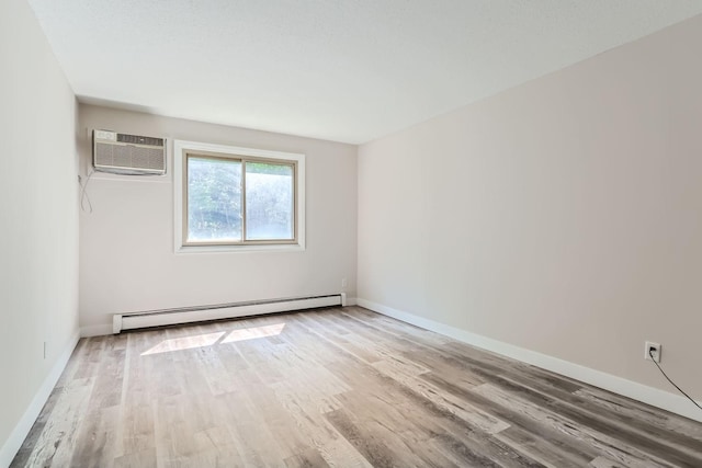 unfurnished room featuring a wall mounted air conditioner, a baseboard radiator, and light hardwood / wood-style floors