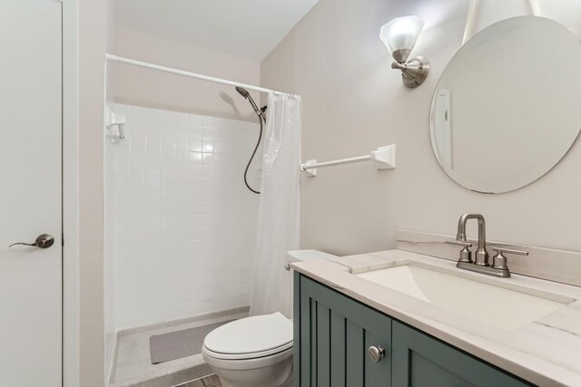 bathroom featuring vanity, toilet, and curtained shower