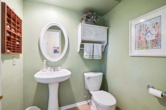 bathroom featuring toilet and tile patterned flooring