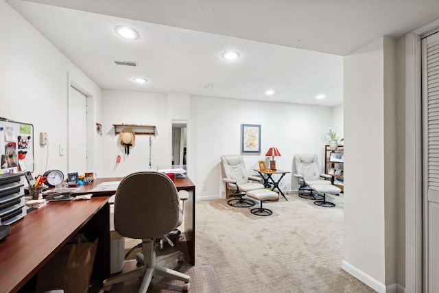 carpeted office featuring a textured ceiling