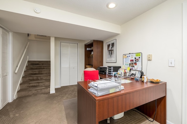 office space featuring dark carpet and a textured ceiling