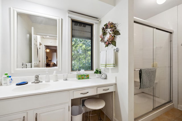 bathroom with vanity, an enclosed shower, and tile patterned flooring