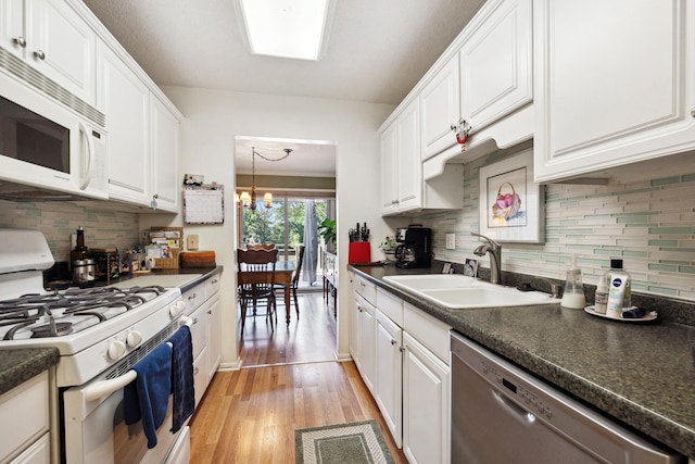 kitchen with light hardwood / wood-style flooring, white cabinetry, and white appliances