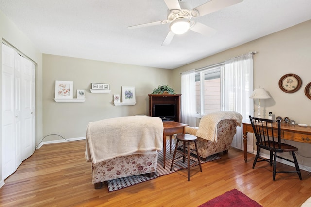 bedroom with a closet, light wood-type flooring, and ceiling fan