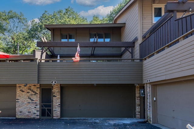 exterior space featuring a garage and a balcony