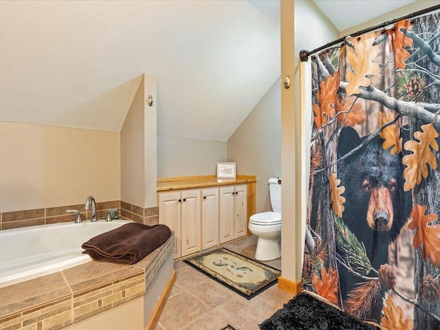 bathroom with a relaxing tiled tub, vaulted ceiling, tile patterned floors, and toilet