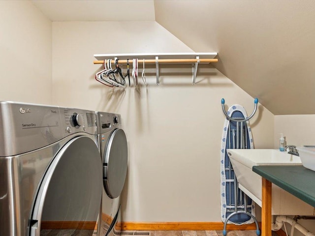 clothes washing area featuring washing machine and dryer