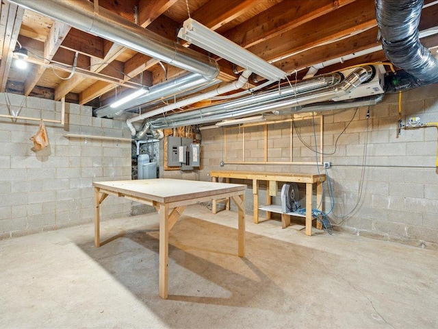 basement with electric panel and a workshop area