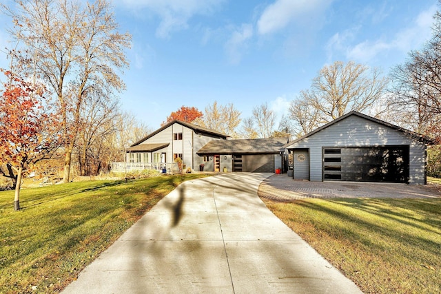 view of front of property with a front yard and a garage