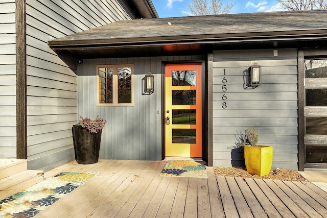 view of exterior entry with a wooden deck