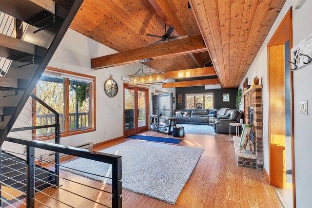 living room with light wood-type flooring, wood ceiling, a brick fireplace, beamed ceiling, and baseboard heating