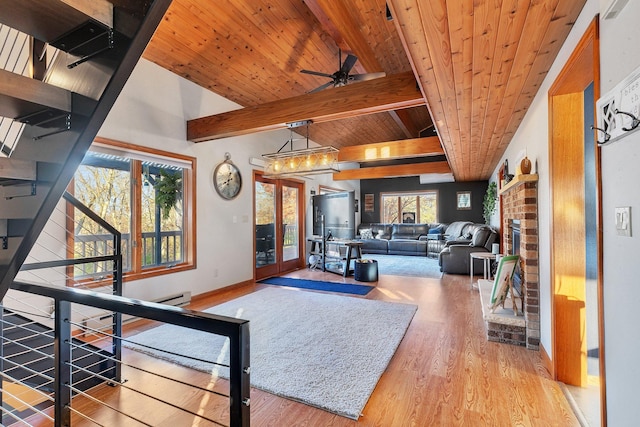 16568 Maplewood Rd, Wakefield Twp, MN 56320 - living room with wood ceiling with exposed beams, wood finished floors, ceiling fan, baseboards, and a brick fireplace