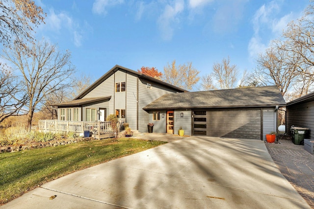 16568 Maplewood Rd, Wakefield Twp, MN 56320 - view of front of home featuring concrete driveway, a front yard, a deck, and an attached garage