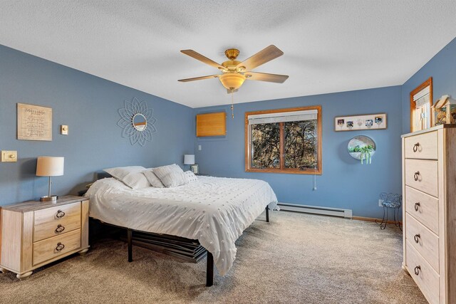 bedroom featuring ceiling fan, baseboard heating, a textured ceiling, and carpet floors