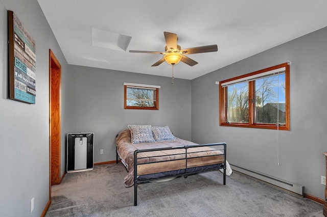 16568 Maplewood Rd, Wakefield Twp, MN 56320 - carpeted bedroom with baseboard heating, baseboards, and a ceiling fan
