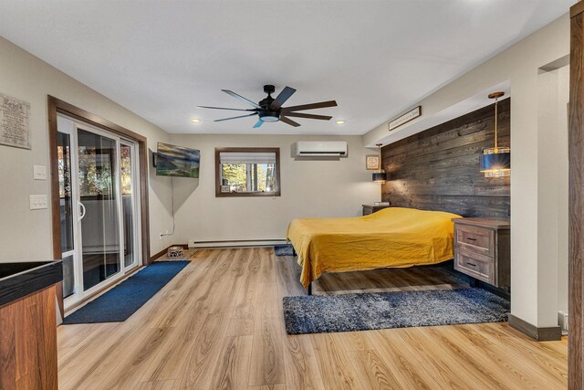 bedroom with access to outside, a baseboard radiator, ceiling fan, light hardwood / wood-style flooring, and an AC wall unit