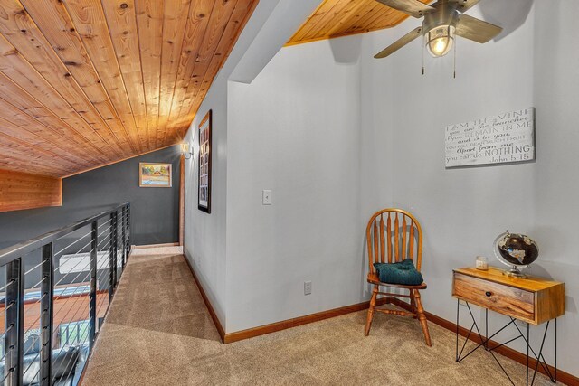 sitting room with wood ceiling, vaulted ceiling, light carpet, and ceiling fan