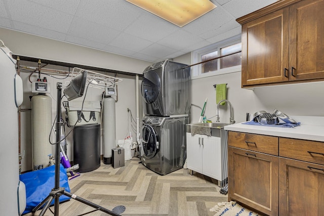 16568 Maplewood Rd, Wakefield Twp, MN 56320 - washroom featuring stacked washer and clothes dryer and cabinet space