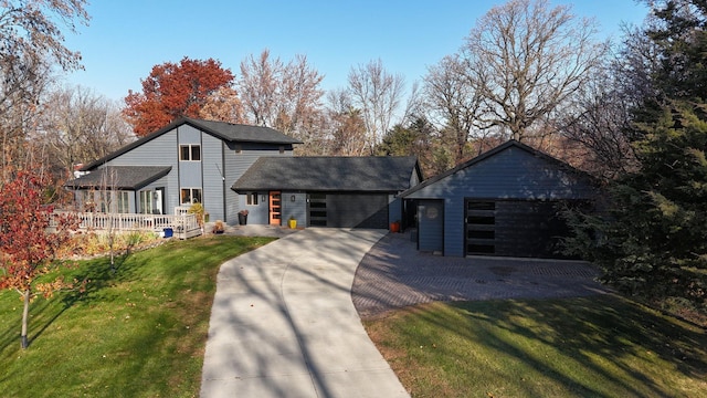 16568 Maplewood Rd, Wakefield Twp, MN 56320 - mid-century modern home featuring a porch, a front yard, a detached garage, and a shingled roof