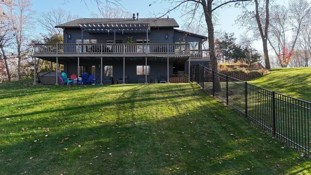 back of house featuring a wooden deck and a yard