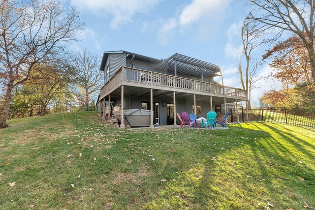 rear view of house featuring a lawn, a patio, and a deck