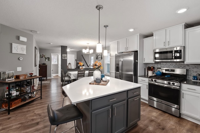 kitchen featuring appliances with stainless steel finishes, white cabinets, and dark hardwood / wood-style flooring