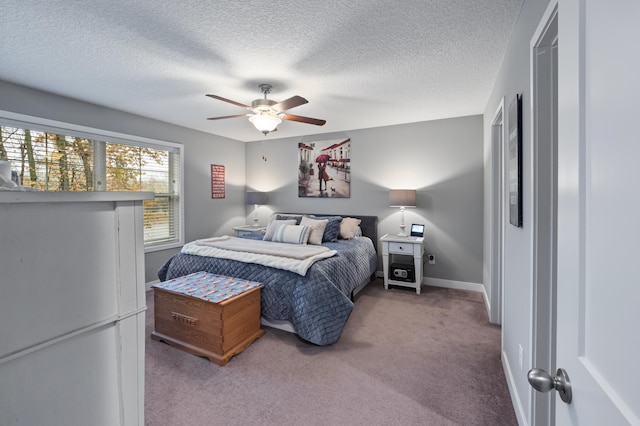 bedroom with a textured ceiling, carpet, and ceiling fan