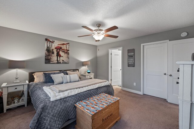 carpeted bedroom with a textured ceiling and ceiling fan