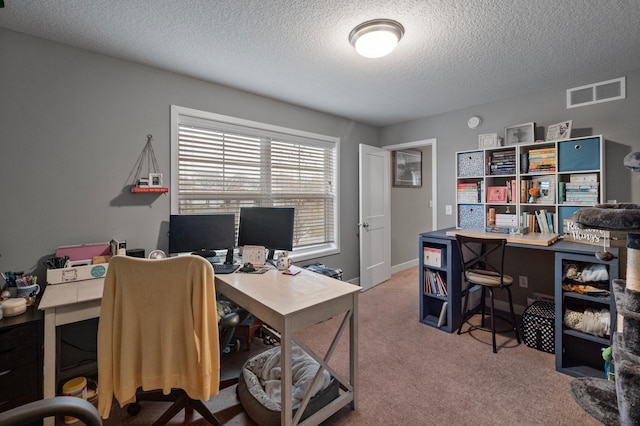 office with a textured ceiling and carpet floors