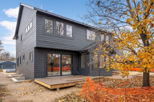 back of house with a wooden deck