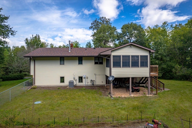 rear view of house with a yard