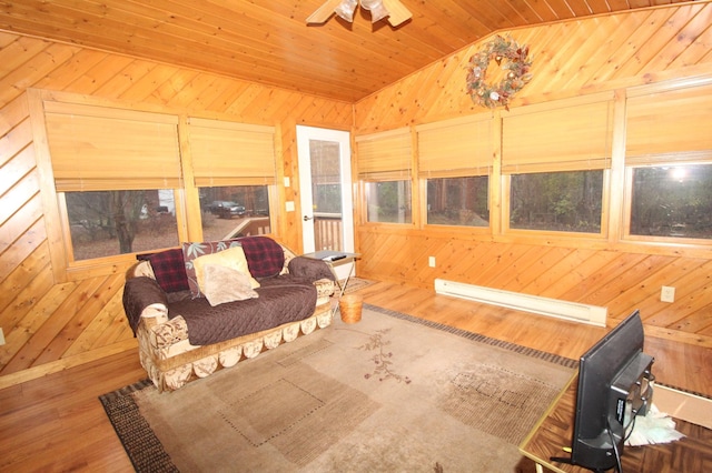 living room with wood walls, lofted ceiling, and wood-type flooring