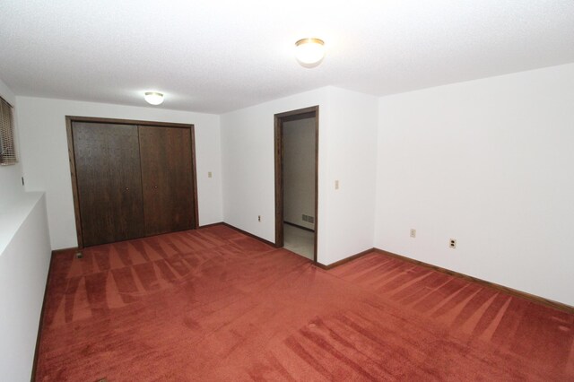 unfurnished bedroom featuring carpet floors and a closet