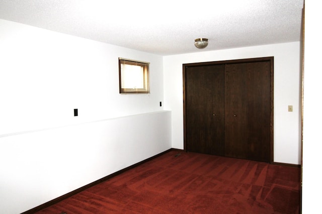 unfurnished bedroom featuring dark hardwood / wood-style floors, a textured ceiling, and a closet