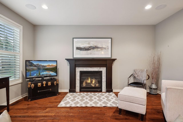 living area featuring a healthy amount of sunlight and dark hardwood / wood-style flooring