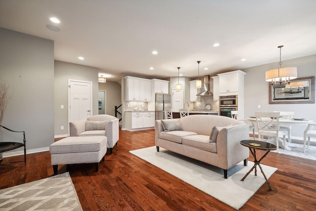 living room with a chandelier and dark hardwood / wood-style flooring