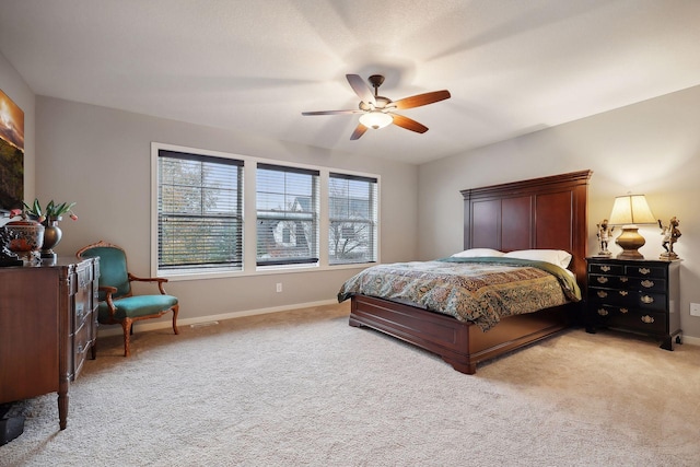 bedroom featuring light colored carpet and ceiling fan