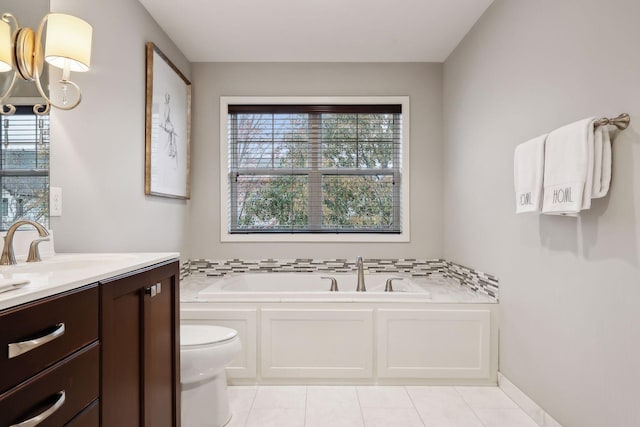 bathroom featuring vanity, a wealth of natural light, tile patterned flooring, and a washtub