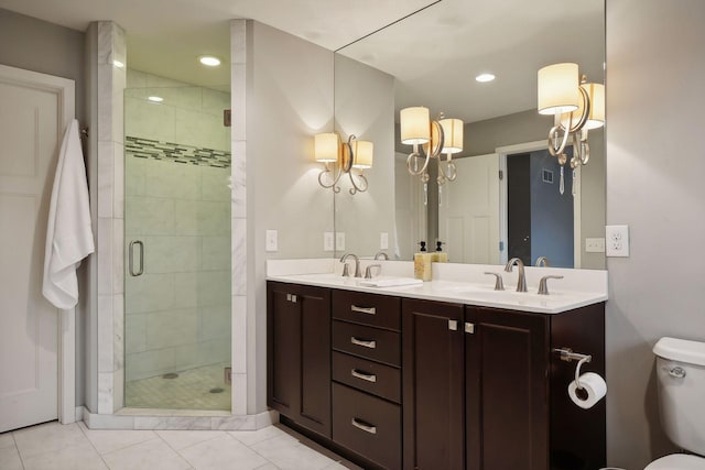 bathroom with vanity, tile patterned flooring, toilet, and walk in shower