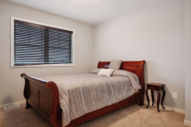 bedroom featuring light carpet