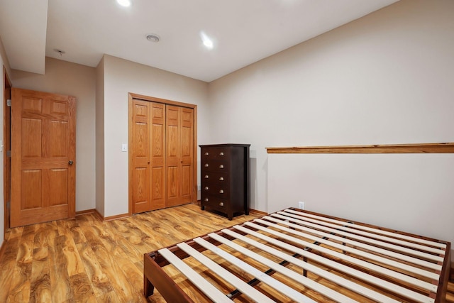 unfurnished bedroom featuring a closet and light hardwood / wood-style flooring