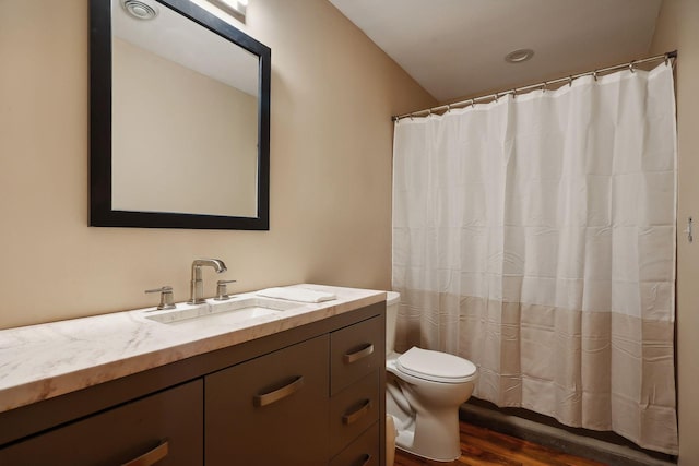 bathroom with vanity, toilet, wood-type flooring, and walk in shower