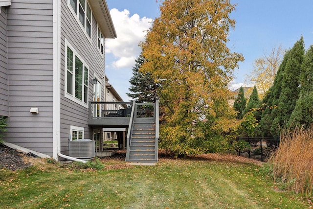 view of yard featuring a deck and central AC unit