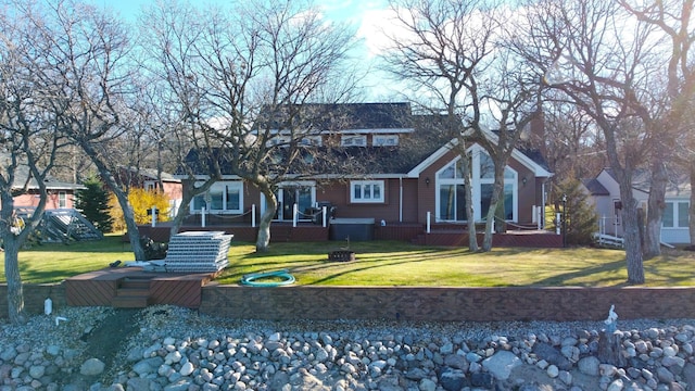 view of front of home featuring a wooden deck and a front lawn