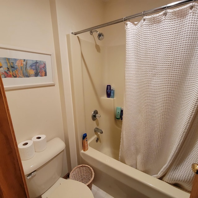 bathroom with toilet and shower / tub combo