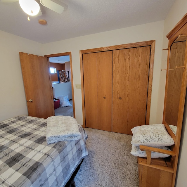 carpeted bedroom with a closet and ceiling fan